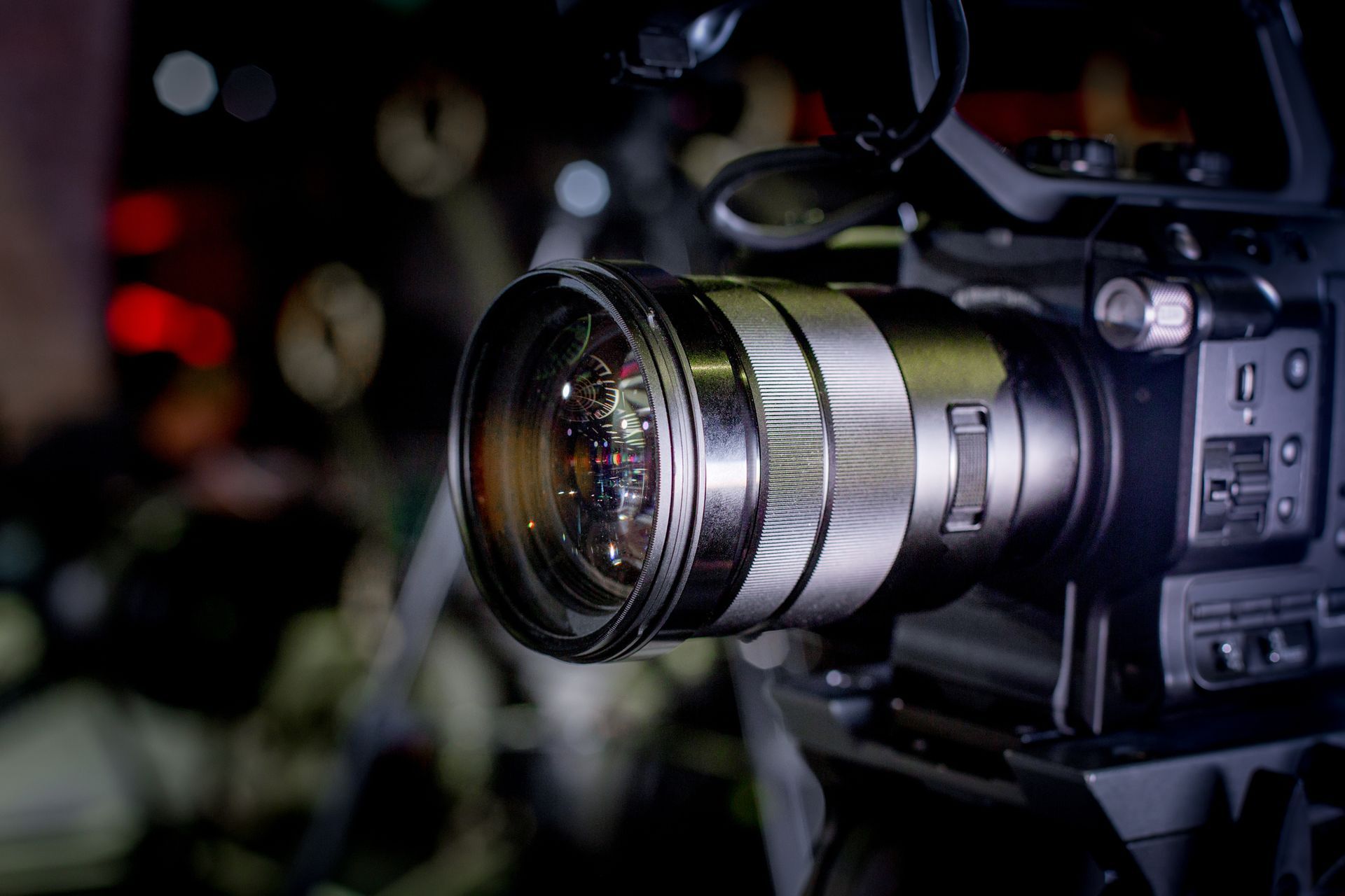 A close up of a video camera in a dark room.