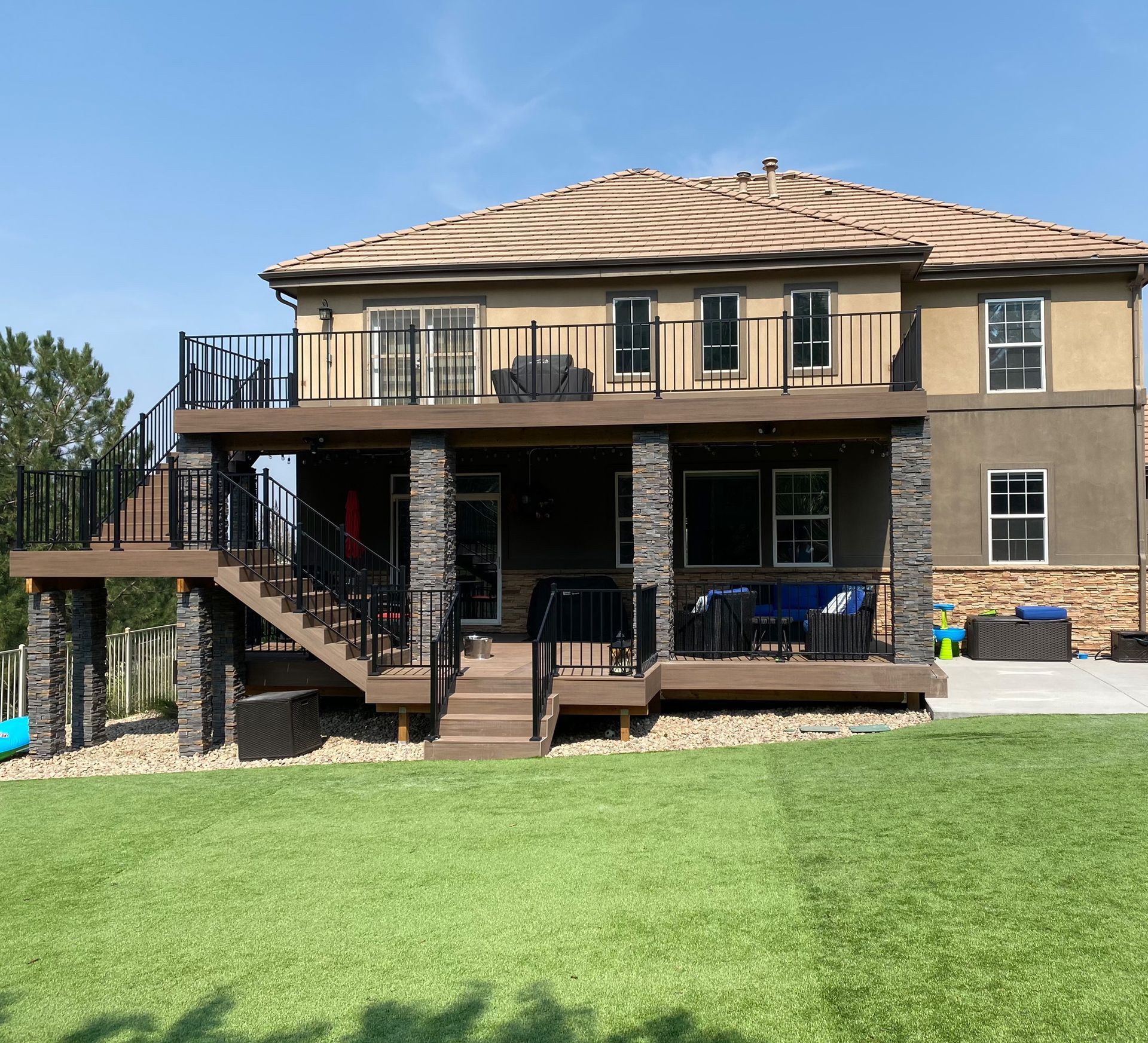 A large house with a large deck and stairs