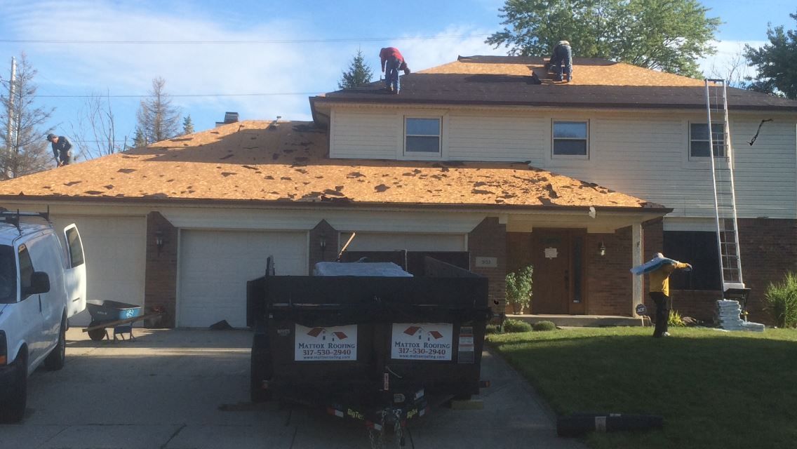 A truck is parked in front of a house that is being remodeled.