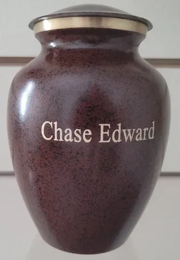 A brown vase with the name chase edward on it