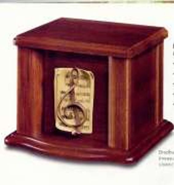 A wooden box with a gold treble clef on it.