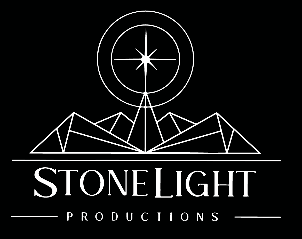 White StoneLight Productions logo: Mountains under a star compass.