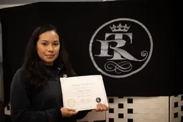 Woman in black holding certificate | Sylmar, CA | Rave Beauty Bar