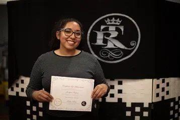 Woman smiling with glasses holding certificate | Sylmar, CA | Rave Beauty Bar