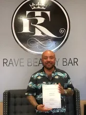 Man in green polo holding certificate | Sylmar, CA | Rave Beauty Bar