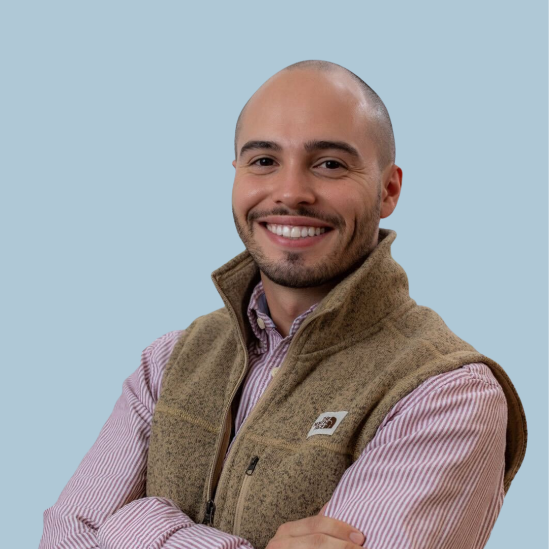 A man wearing a vest with the north face logo on it