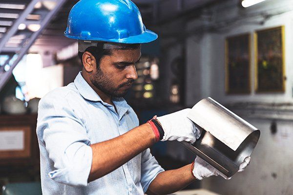 man holding bended sheet metal