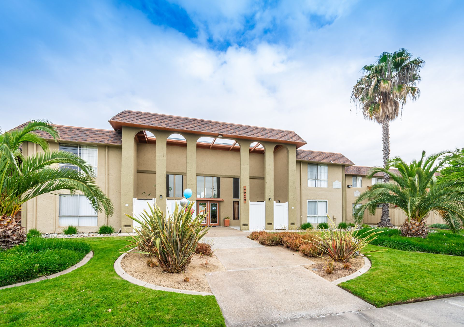 A large building with palm trees in front of it
