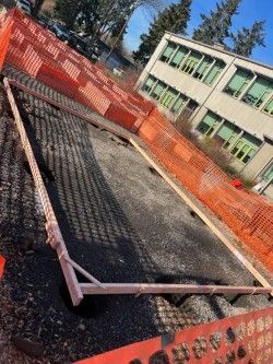 A person is using a circular saw on a concrete floor.