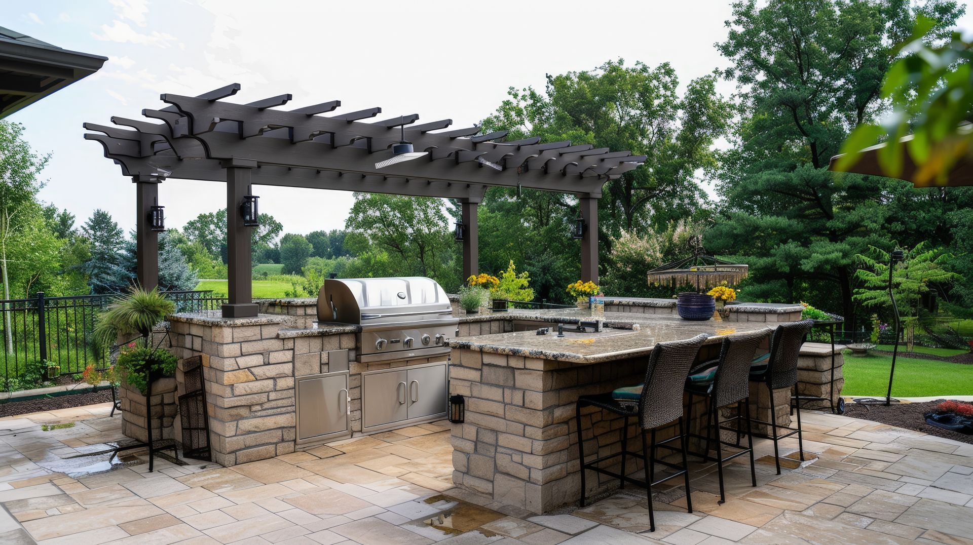 Outdoor kitchen with grill, refrigerator, and Big Green Egg on a stone patio.