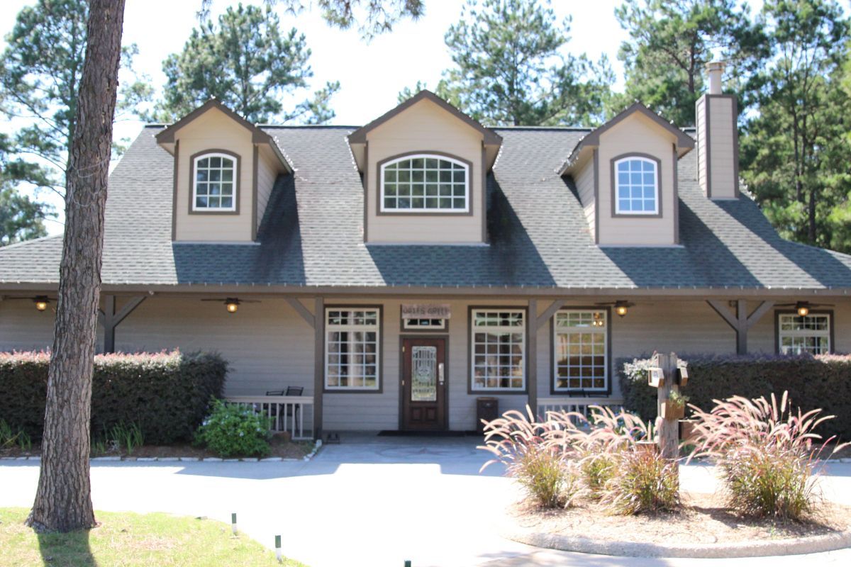 A large house with a lot of windows and a chimney