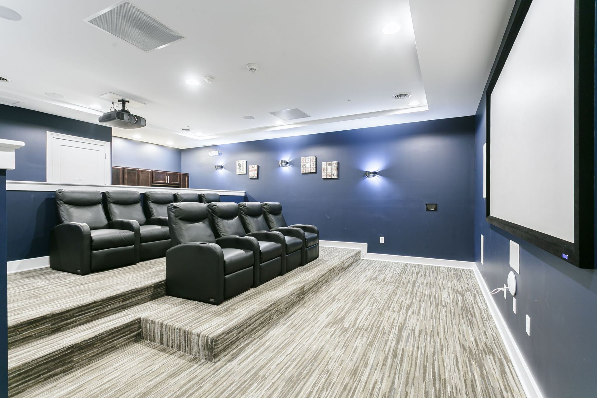 Theater room with reclining chairs and kitchenette