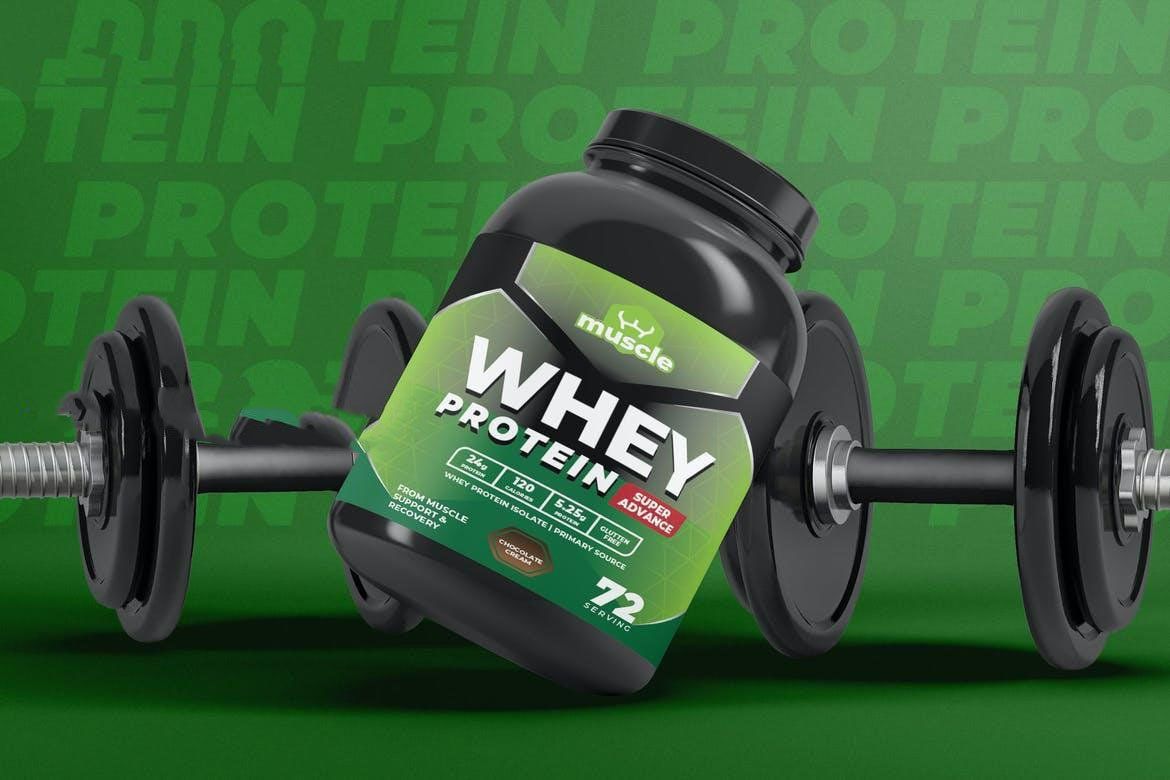 A bottle of whey protein powder is sitting on top of a pair of dumbbells.