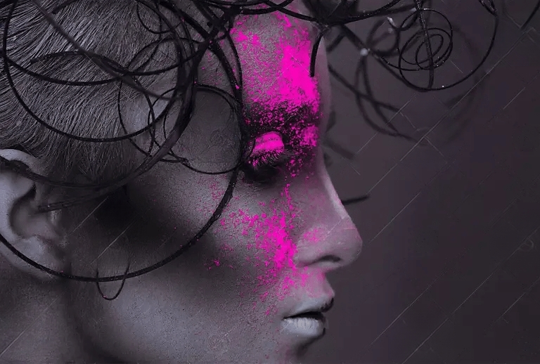 A close up of a woman 's face with pink paint on it.