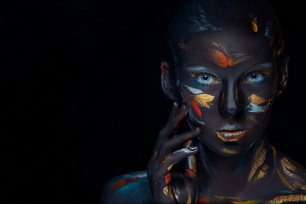 A woman with body paint on her face and body.