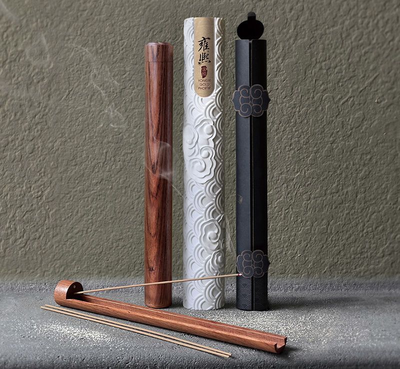 Three incense sticks are sitting on a table next to each other.