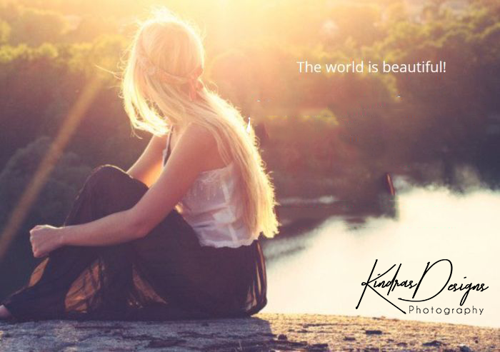 A woman is sitting on a rock in front of a body of water.