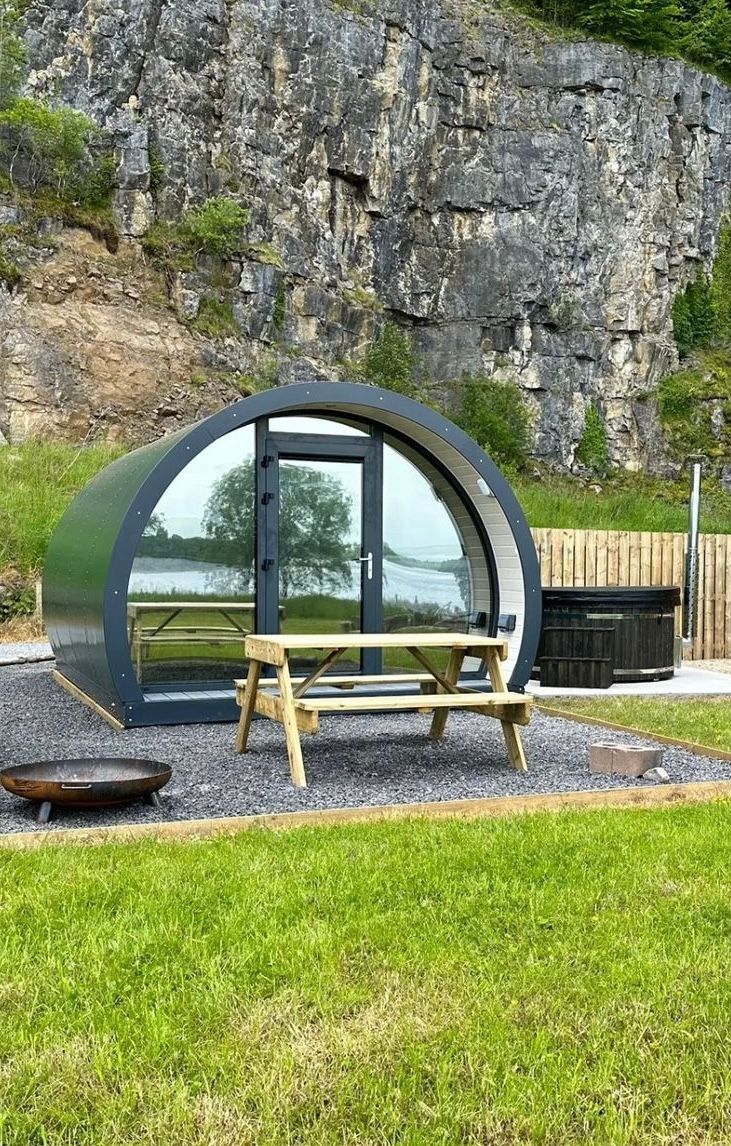A small house with a picnic table in front of it.