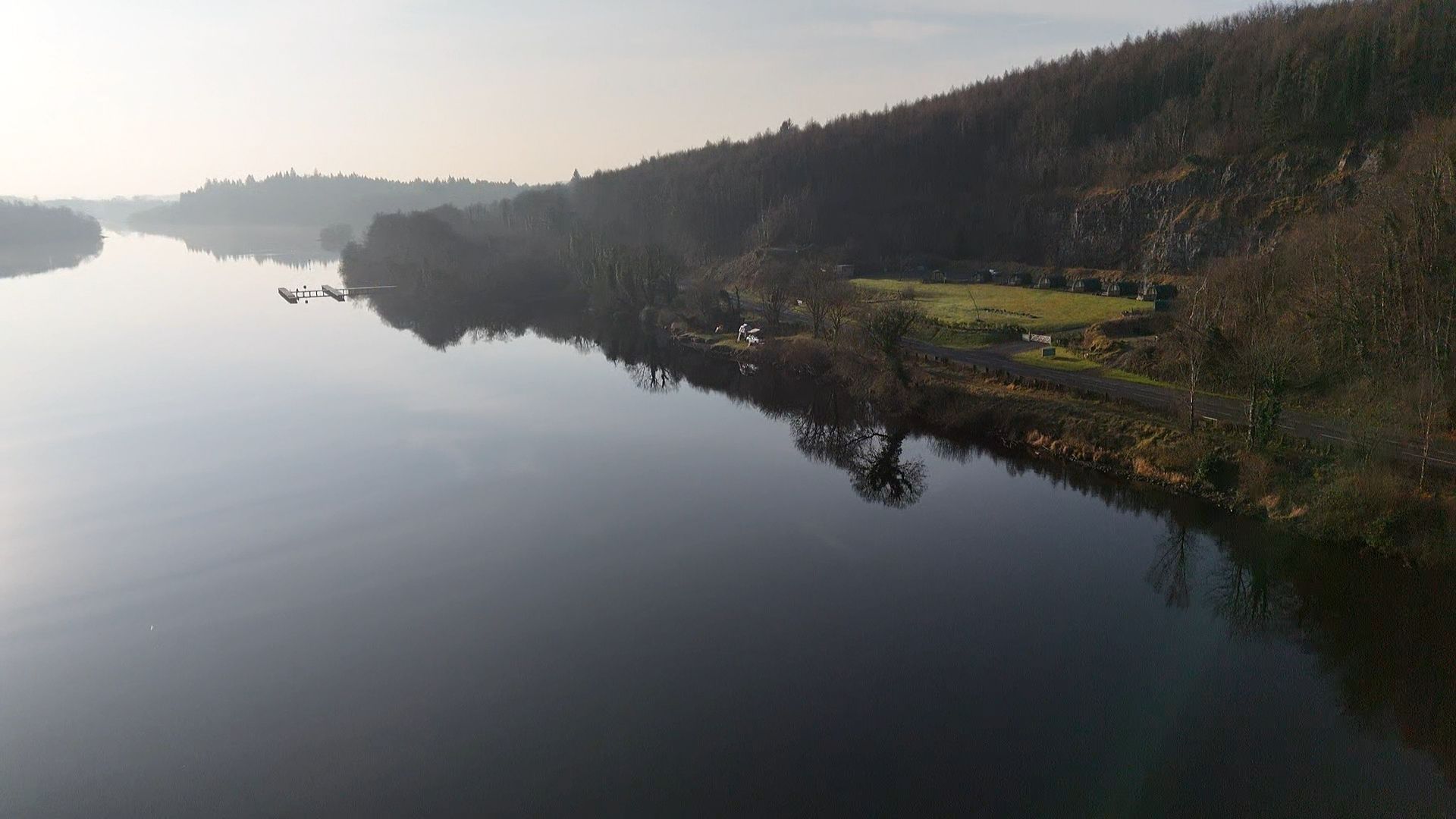 An aerial view of a large body of water surrounded by trees.