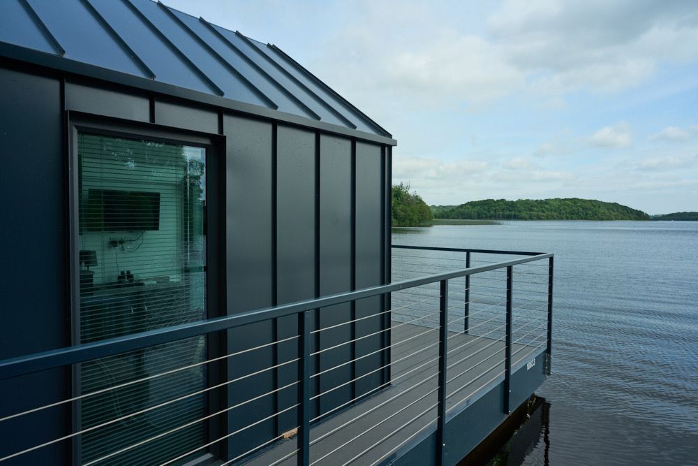 A house with a balcony overlooking a lake