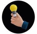 Hand holding a glowing yellow lightbulb, suggesting an idea.