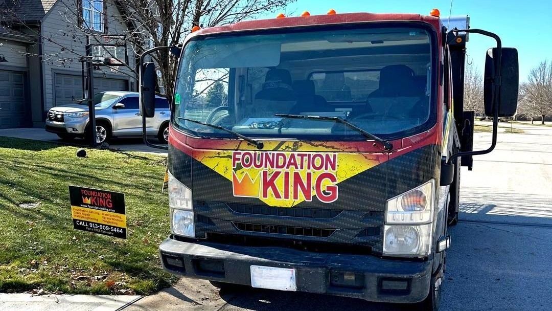 A foundation king truck is parked in front of a house.