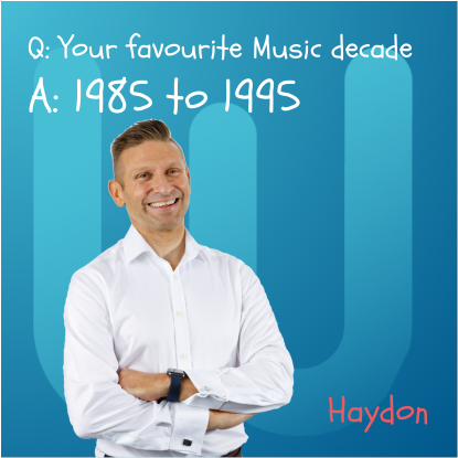 Man with crossed arms smiling. Text: 