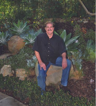 Man Seating on Huge Rock — Newport Beach, CA — Urban Landscape