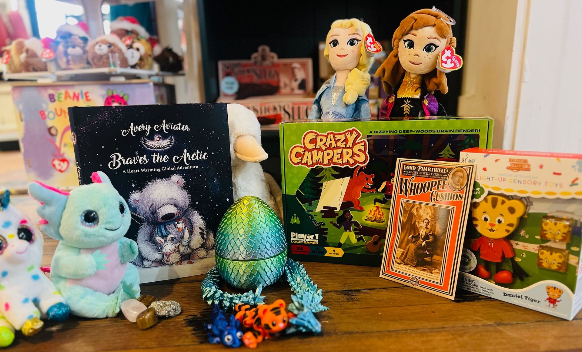 A bunch of stuffed animals and books are sitting on a table.