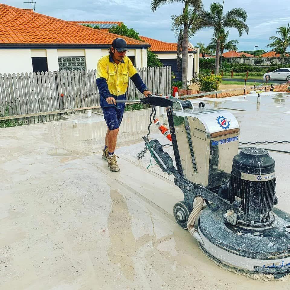Man Operating a Concrete Grinder on a Freshly Poured Slab — Showcase Concrete & Polishing in Moore Park Beach, QLD