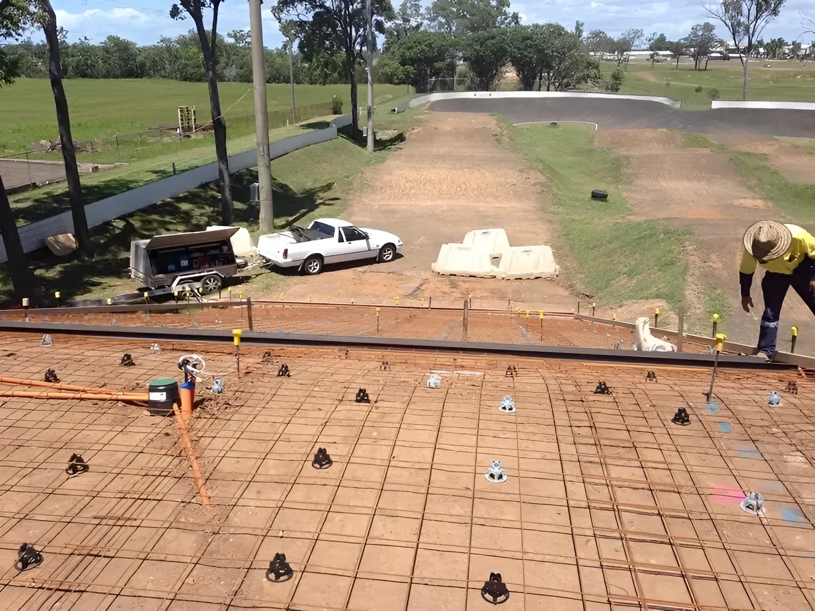 Construction Site With Rebar Grid, Work Truck — Showcase Concrete & Polishing in Moore Park Beach, QLD