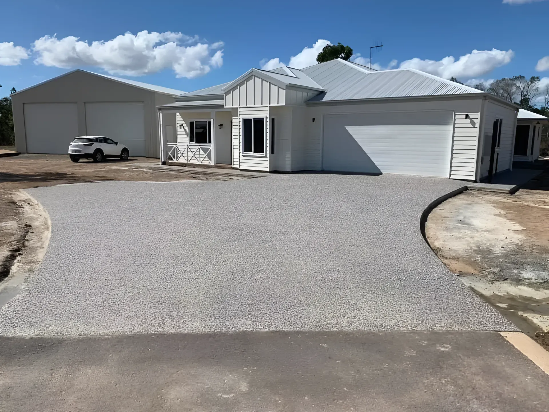 White House With Exposed Aggregate Driveway — Showcase Concrete & Polishing in Moore Park Beach, QLD