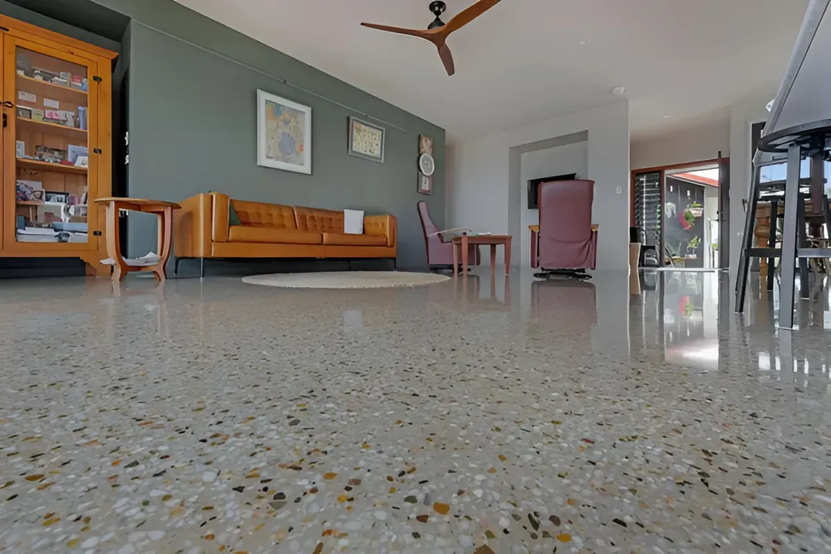 Polished Concrete Floor in Living Room With a Tan Leather Sofa — Showcase Concrete & Polishing in Moore Park Beach, QLD