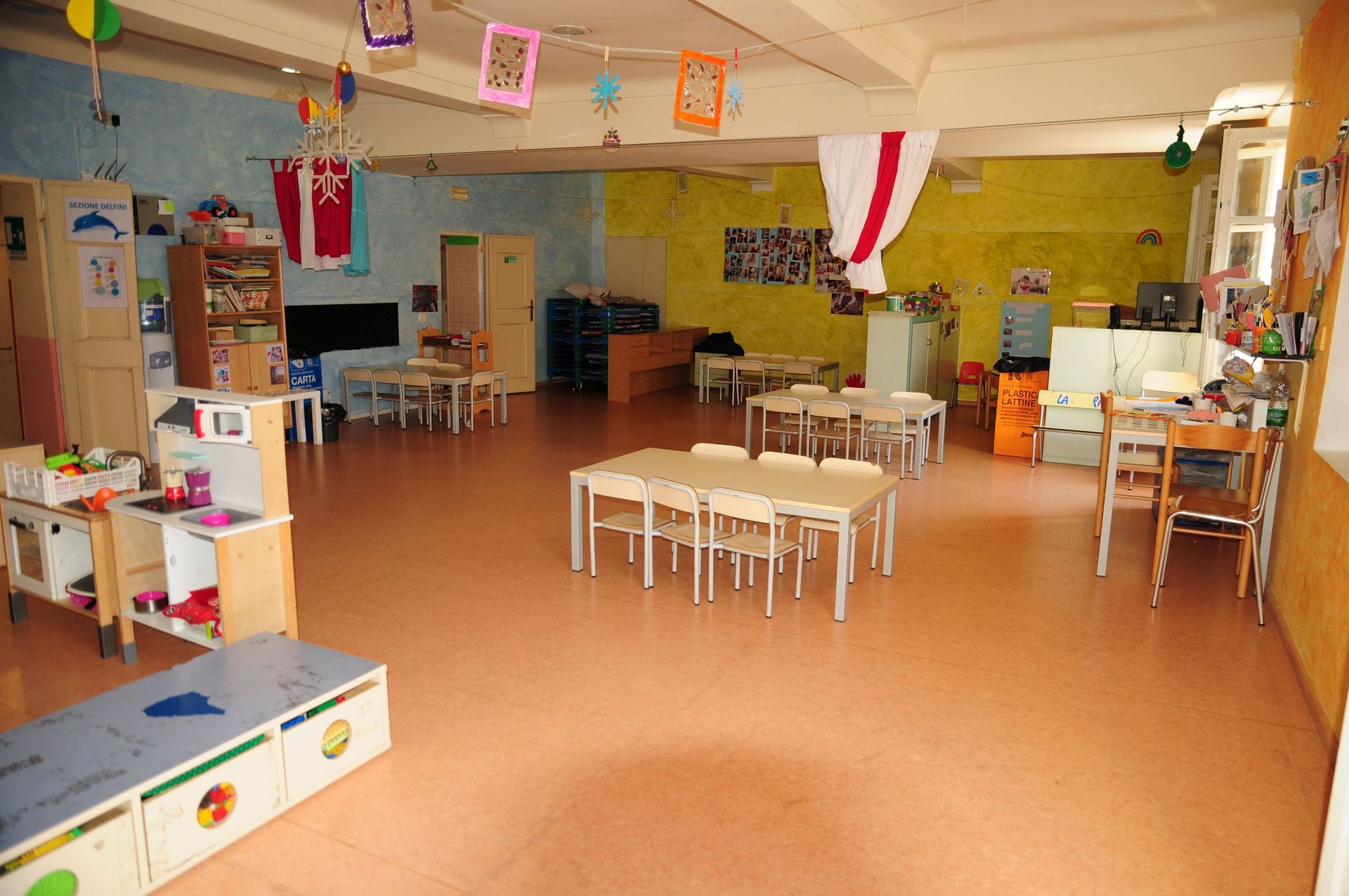 Una grande stanza con tavoli e sedie