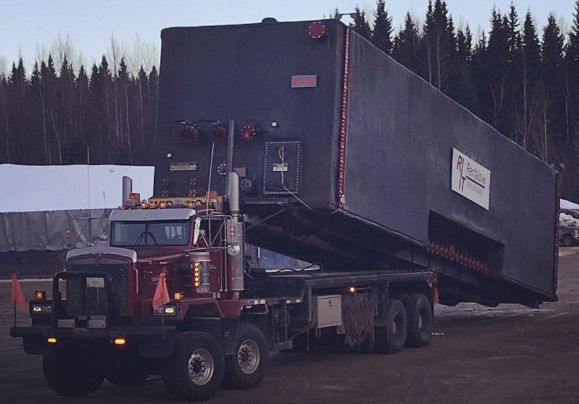 Winch tractor and super b trailers hauling well heads in Grande Prairie, Alberta