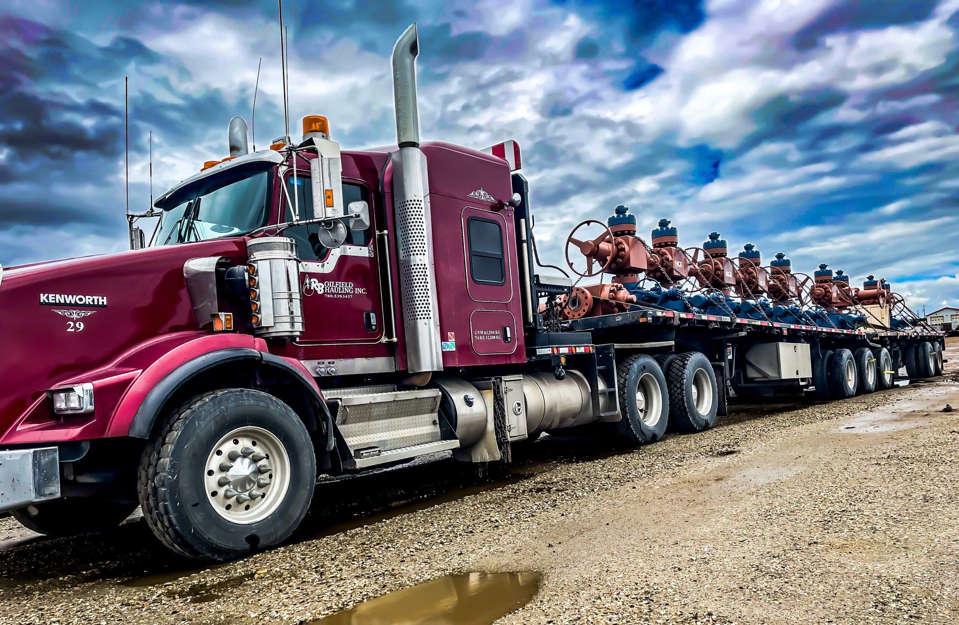 Winch tractor and super b trailers hauling well heads in Grande Prairie, Alberta