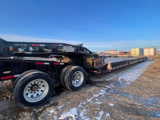 A picture of a black trailer in a Grande Prairie yard.