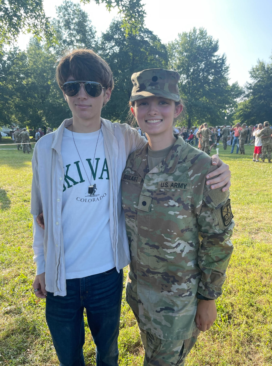 A man and a woman in military uniforms are posing for a picture.