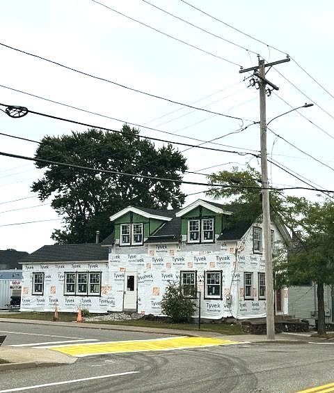 A house is being built on the corner of a street.