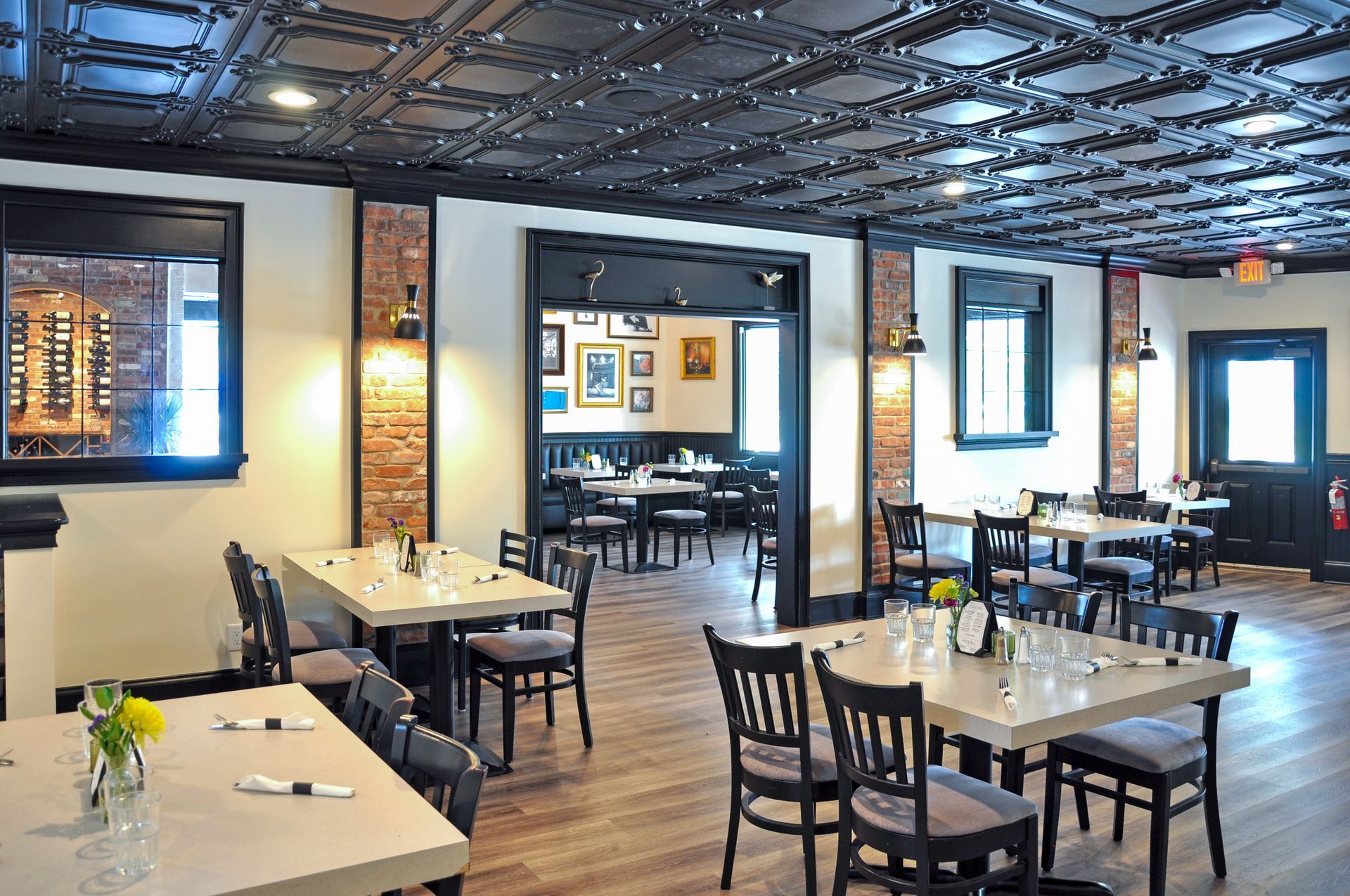 A restaurant with tables and chairs and a black ceiling