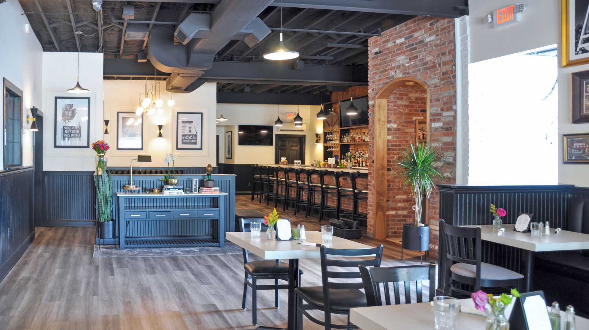 A restaurant with tables and chairs and a bar.