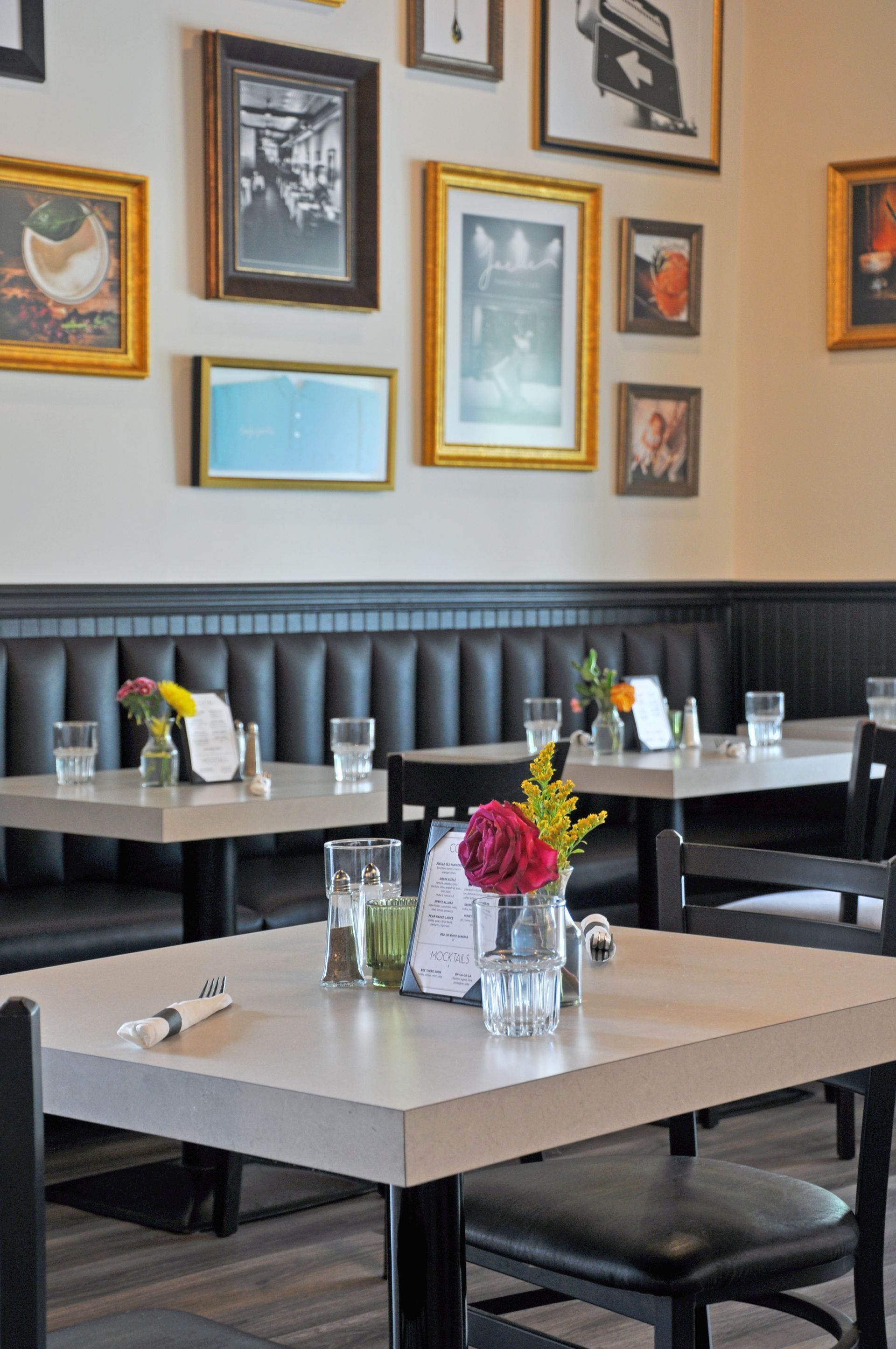 A restaurant with tables and chairs and pictures on the wall