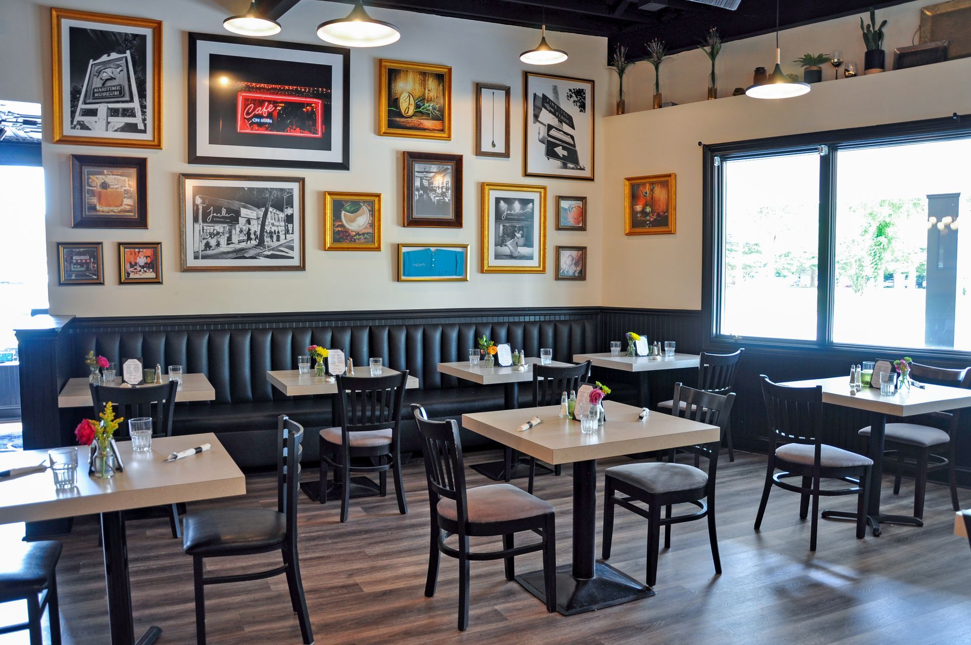 A restaurant with tables and chairs and pictures on the wall.