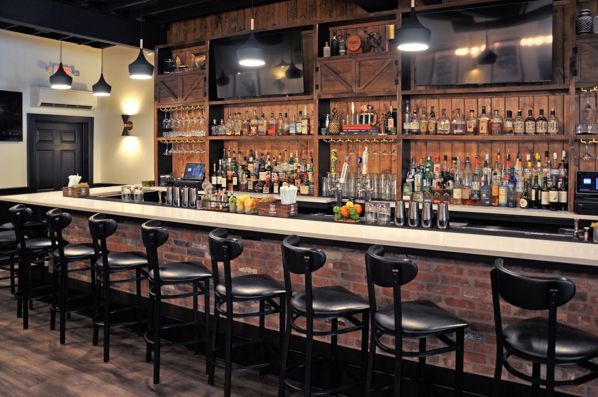 A long bar with a lot of bottles on it