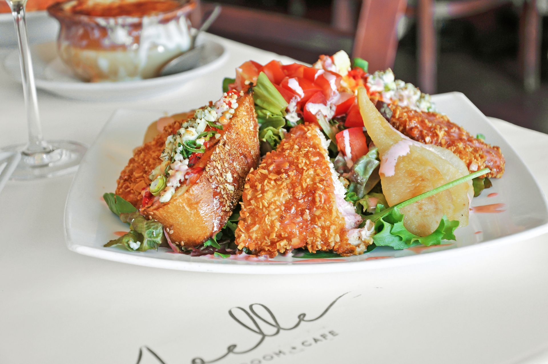 A plate of food on a table with a sign that says belle cafe
