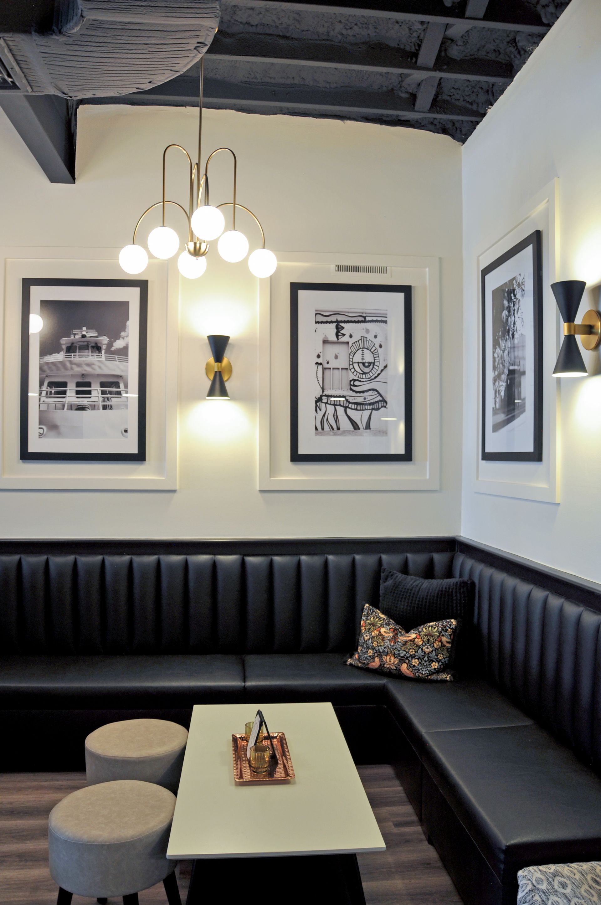 A corner of a room with a couch and a table