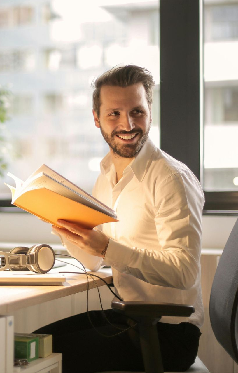 a man and a woman are looking at a laptop computer .