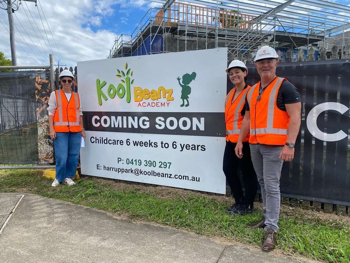 A Group of Workers Are Standing in Front of A Sign that Says Coming Soon — Mass Construction Group Australia Pty Ltd in South Mackay, QLD