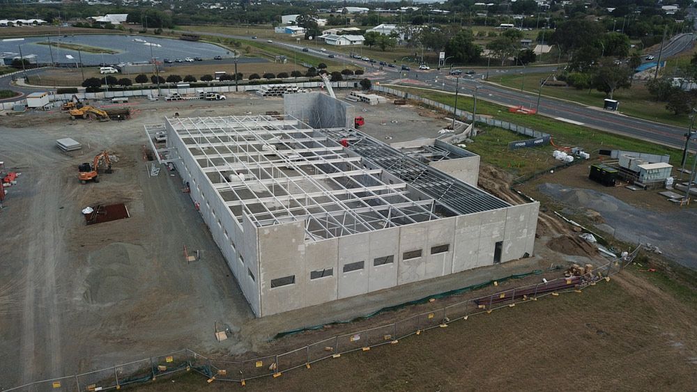 An Aerial View of A Large Building Under Construction in A City — Mass Construction Group Australia Pty Ltd in South Mackay, QLD