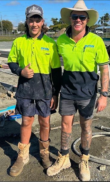 Two Men Are Standing Next to Each Other on A Construction Site — Mass Construction Group Australia Pty Ltd in South Mackay, QLD